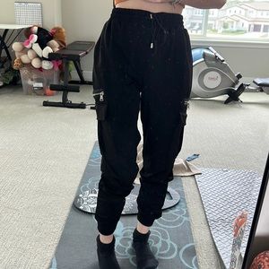 Black joggers with zippered pockets on each leg